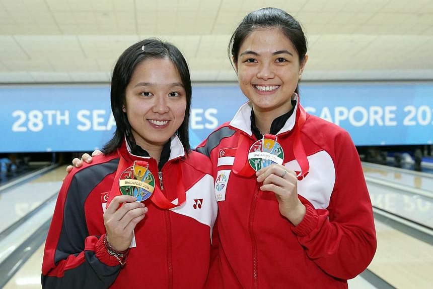 (Left-right) Singapore's Jazreel Tan and Daphne Tan finishing first and second respectively in the bowling women's masters final of the 28th SEA Games on Sunday, on June 14, 2015, at the Orchid Country Club.&nbsp;-- ST PHOTO:&nbsp;SEAH KWANG PENG