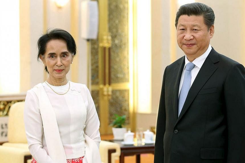 China's President Xi Jinping and Myanmar pro-democracy leader Aung San Suu Kyi pose for pictures during their meeting at the Great Hall of the People in Beijing, China, on June 11, 2015. The Myanmar opposition leader wrapped up her first visit to Chi
