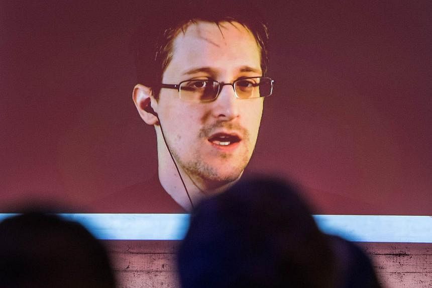 US National Security Agency (NSA) whistleblower Edward Snowden speaks via live video call during the CeBIT technology fair in Hanover, central Germany, on March 18, 2015. Britain has pulled out agents from live operations in "hostile countries" after