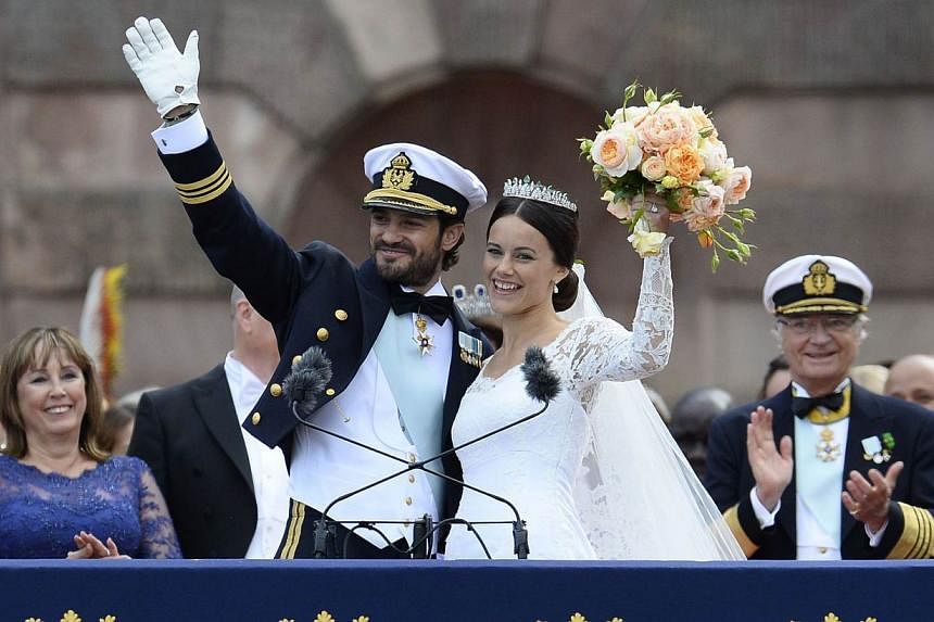 Sweden's Princess Sofia and Sweden's Prince Carl Philip greet the crowds after their wedding ceremony at Stockholm Palace on June 13, 2015. &nbsp;-- PHOTO: AFP