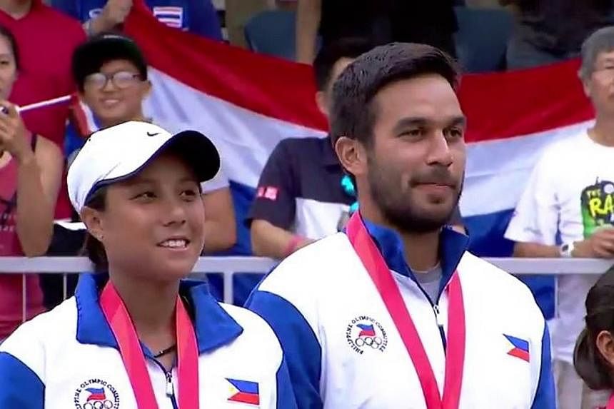 Denise Dy (left) and Treat Huey of the Philippines after receiving their gold medals for winning the tennis mixed doubles at the SEA Games. The victory by Dy and Huey prevented the Thais from getting a clean sweep of all the tennis golds at the games