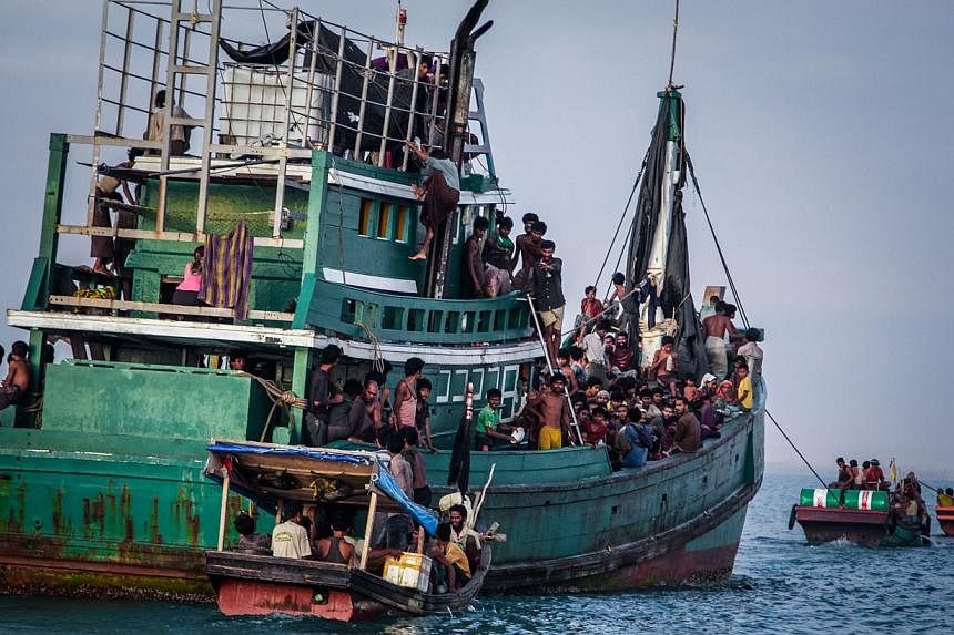 Rohingya migrants resting on a boat off the coast near Kuala Simpang Tiga in Indonesia's East Aceh district of Aceh province before being rescued. -- PHOTO: AFP&nbsp;