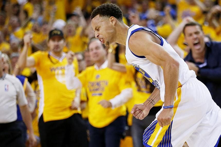 Stephen Curry of the Golden State Warriors celebrates in the second quarter against the Cleveland Cavaliers during Game Five of the 2015 NBA Finals at the Oracle Arena on June 14, 2015 in Oakland, California. -- PHOTO: AFP&nbsp;