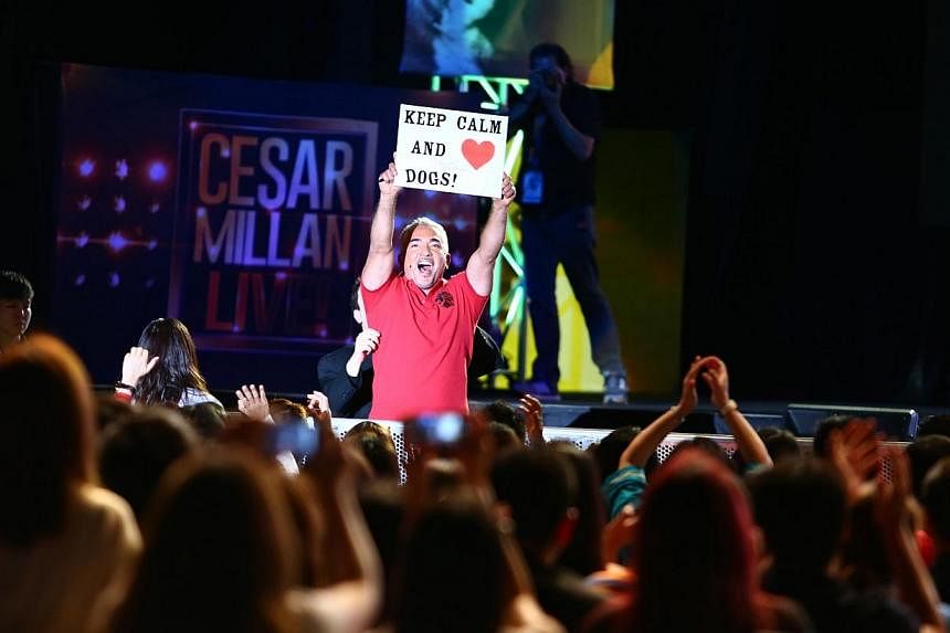 Dog trainer Cesar Millan with a sign made by a fan at his show. -- PHOTO: UNUSUAL ENTERTAINMENT