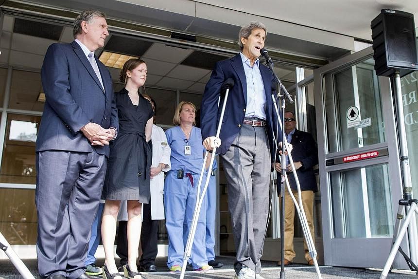 Secretary of State John Kerry speaks to the press on crutches after being discharged from Massachusetts General Hospital on June 12, 2015 in Boston, Massachusetts.&nbsp;Mr Kerry is taking nothing more than pain relief medicine Tylenol for his broken 