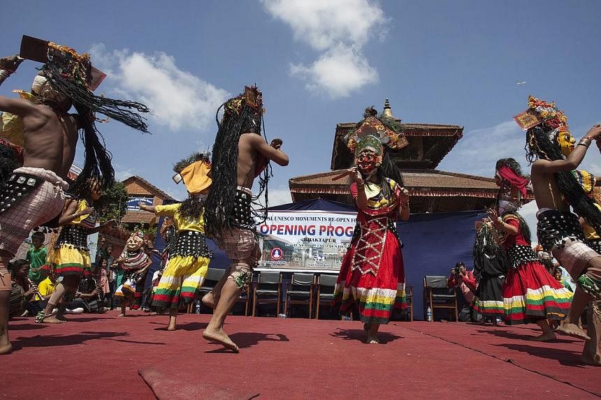 Local artists perform a ritual dance during the opening of Bhaktapur to tourists at Darabar Square, Bhaktapur, Nepal, on June 15, 2015.&nbsp;Nepal reopened hundreds of earthquake-damaged monuments at heritage sites on Monday,&nbsp;trying to draw visi