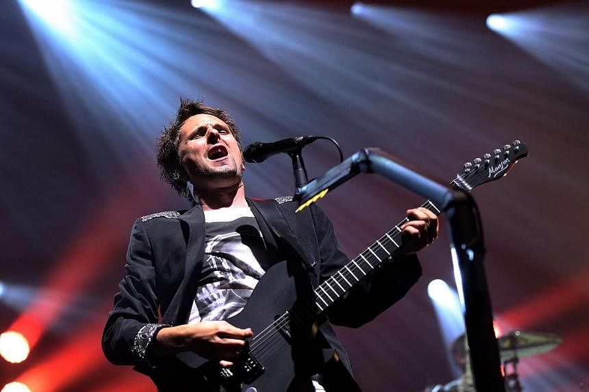 Matthew Bellamy of British rock band &nbsp;Muse performs at the Olympia concert hall in Paris. -- PHOTO: AFP
