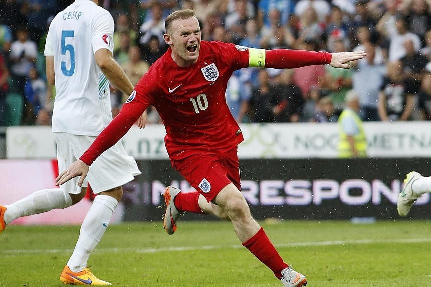 Wayne Rooney celebrates after scoring in the qualifier in Slovenia. -- PHOTO: REUTERS&nbsp;