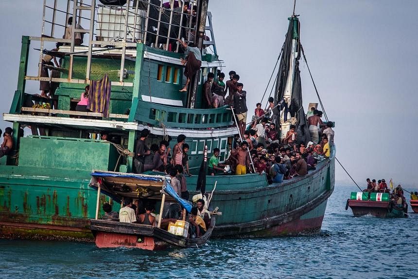 This photograph taken on May 20, 2015 shows Rohingya migrants resting on a boat off the coast near Kuala Simpang Tiga in Indonesia's East Aceh district of Aceh province before being rescued. Australian authorities work within the law to stop asylum s