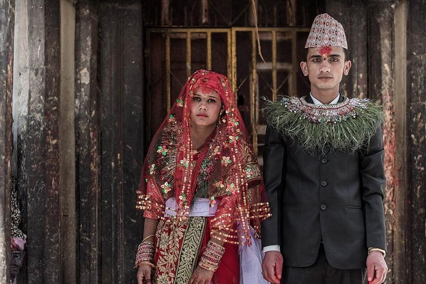 Nepalese couple Anita Thapa, 22, and Sagar KC, 24, at their wedding on May 3 in Kathmandu, which was postponed after the 7.8 magnitude quake on April 25. The disaster made fulfilling nuptial rituals easier, as the need to spend lots of money and fulf