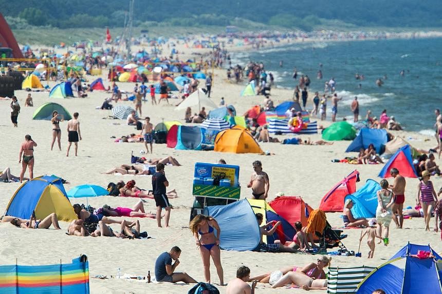 Tourists at the Baltic sea at Zinnowitz on Usedom island, Germany, on June 13, 2015. -- PHOTO: EPA&nbsp;
