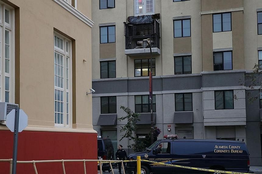 A coroner's vehicle sits parked at the scene of a balcony collapse at an apartment building near UC Berkeley on June 16, 2015, in Berkeley, California. -- PHOTO: AFP