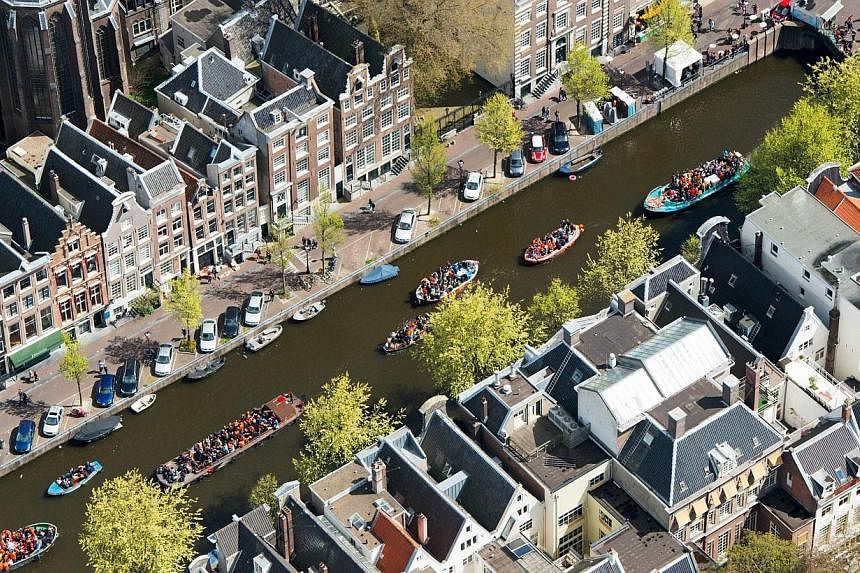 An aerial view of crowded boats in the canals of Amsterdam during King's Day on April 27, 2015, the celebration of the birthday of the King. &nbsp;A Dutch startup has unveiled plans to build the world's first 3D-printed bridge across an Amsterdam can