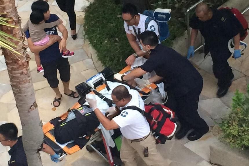 Medics attend to a seven-year-old boy rescued from a swimming pool at Resorts World Sentosa. He was later pronounced dead at Singapore General Hospital. -- PHOTO: WAN BAO&nbsp;