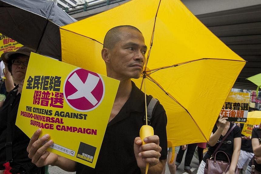 Supporters of real universal suffrage in Hong Kong march through the city streets for the last time ahead of a crucial vote on political reform in the city's Legislative Council, due to take place on 17 or 18 June, in Hong Kong, China, on June 14, 20