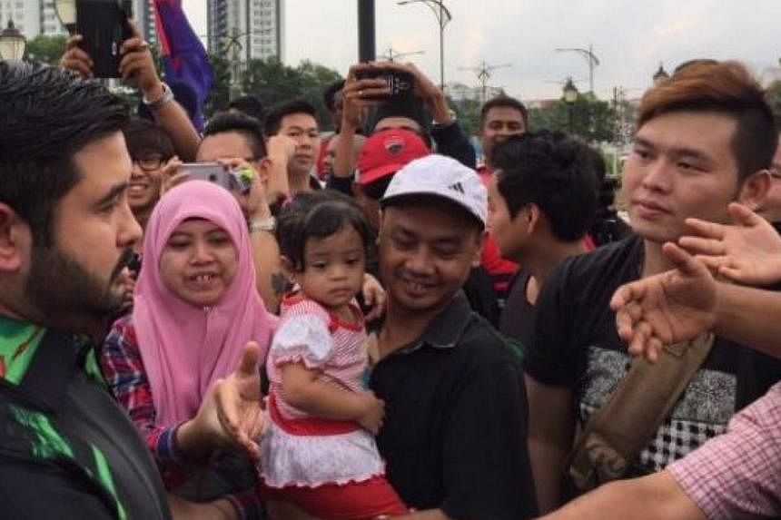 Crown Prince Tunku Ismail Sultan Ibrahim (left), mingling with the crowd that has shown up in support of the Johor Royalty at the Bukit Serene Royal Palace in Johor Baru on June 16, 2015. -- PHOTO: THE STAR&nbsp;