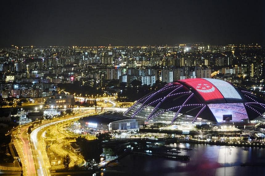 A giant Singapore flag on the roof of the Sports Hub during the 28th SEA Games Opening Ceremony held at the National Stadium on June 5, 2015. -- ST PHOTO: MARK CHEONG&nbsp;