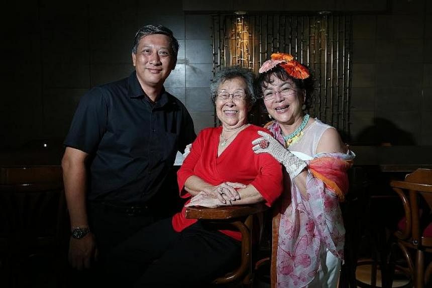 Madam Wee Poh Keok with actress Petrina Fung Bo Bo and Madam Wee's son Fabian Koh in an old photograph (right) and at the Link Hotel yesterday (far right).