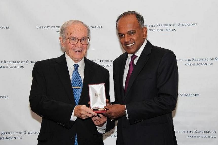 Mr K. Shanmugam (right) presenting the Public Service Star (Distinguished Friends of Singapore) to Mr Newton Minow.