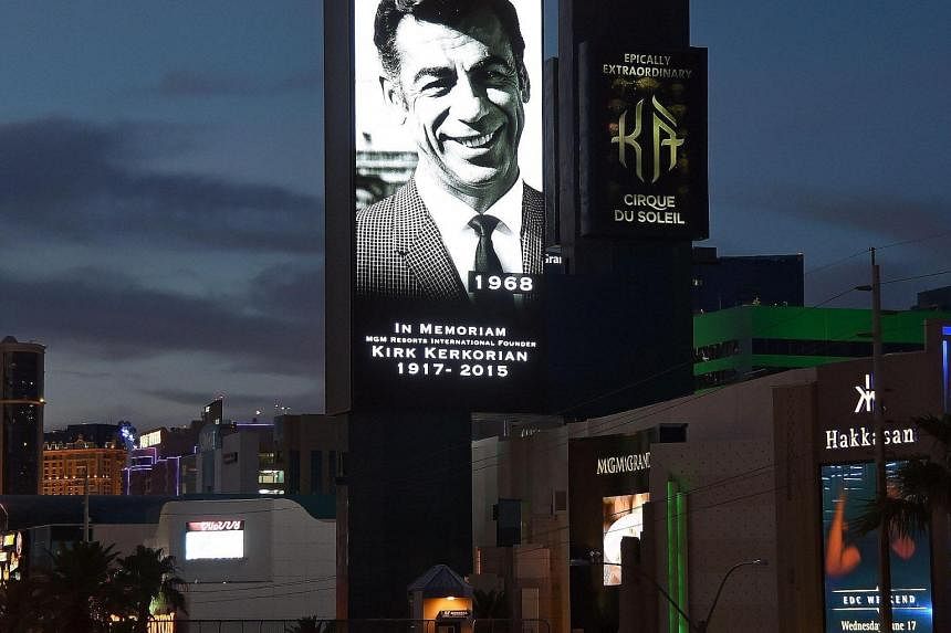 The marquee at MGM Grand Hotel & Casino displays a video tribute (far left) to the late Kirk Kerkorian (left), who founded MGM Resorts International and was its largest shareholder.