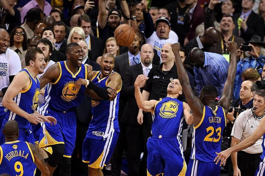 Above, the Golden State Warriors team made sure they did not throw away their 3-2 series lead in Cleveland and held off the Cavaliers to take Game Six, and the NBA crown. Left, Stephen Curry and Finals MVP Andre Iguodala (with towel) foiled LeBron Ja