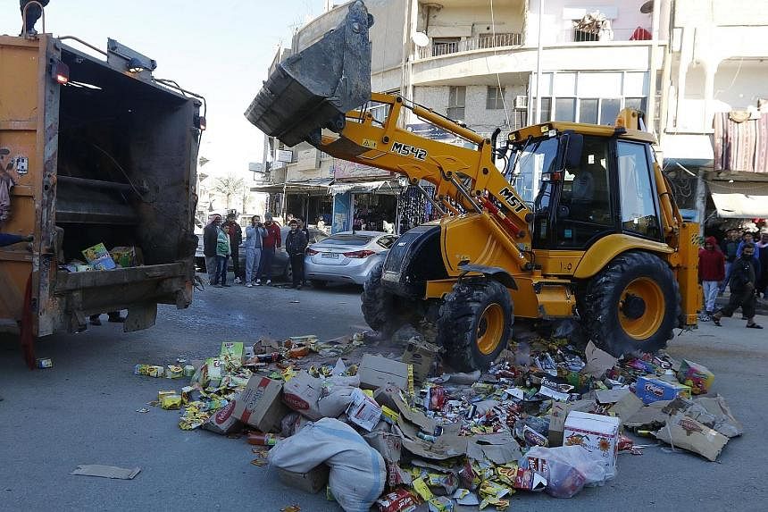 Confiscated products in central Raqqa are disposed of by men who say they were hired by ISIS to monitor the quality of goods in markets. Residents of ISIS-controlled areas do not describe easy lives, but some want the hardliners to stay, reflecting t
