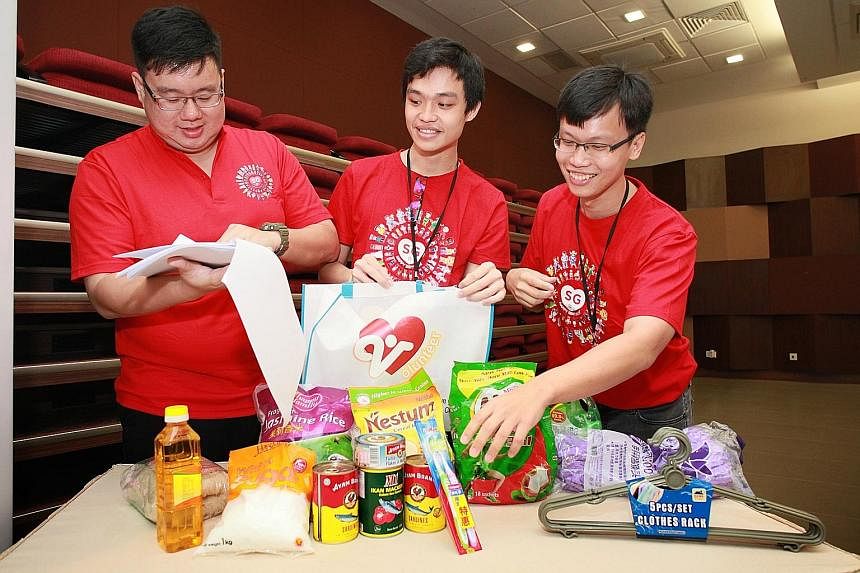 Mr Wong Woei Luen, Mr Teo Si Jie and Mr Elvis Chong checking items - daily necessities - to be added to the funpacks for Jurong Spring residents. Different constituencies have come up with their own ideas on what to add to the funpacks.