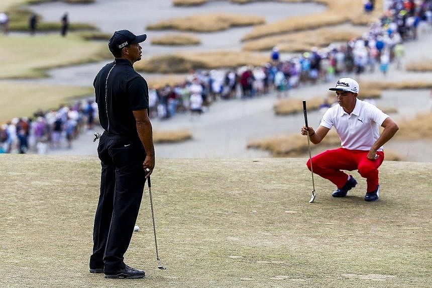 Tiger Woods (far left), having to settle for a bogey five on the fourth hole on Thursday. But he tried to make light of the situation by saying that his 80 score was still better than the 81 achieved by fellow American Rickie Fowler.