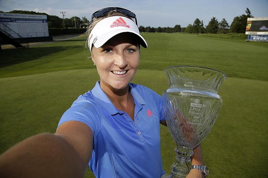 (Left) Anna Nordqvist gave her mum a memorable Swedish Mother's Day when the latter witnessed the golfer's triumph in the ShopRite LPGA Classic in New Jersey on May 31. (Right) A picture of the smashed trophy.