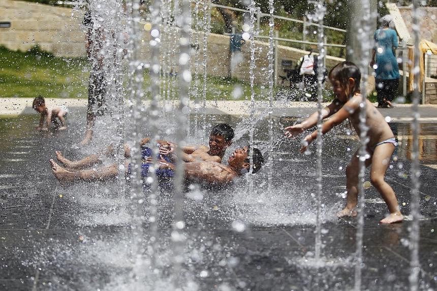 Children getting a respite from heat at a fountain in Jerusalem in May. The planet's air and sea temperatures have been climbing since the start of the year, resulting in 2015 having the warmest first five months of any year.