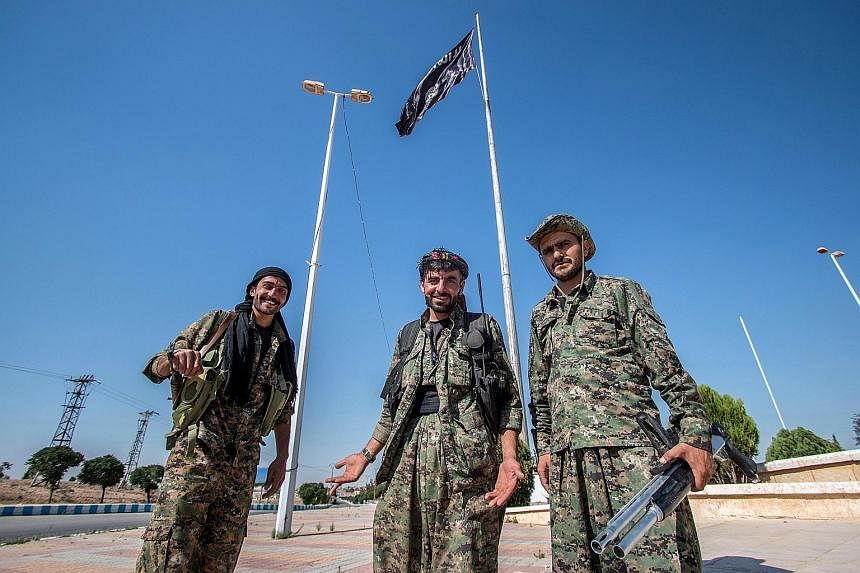 Kurdish People's Protection Units (YPG) fighters in Tal Abyad on the Turkish border. The Kurds retook the key hub this month, one in a string of victories over the jihadists who have been sweeping through the area.