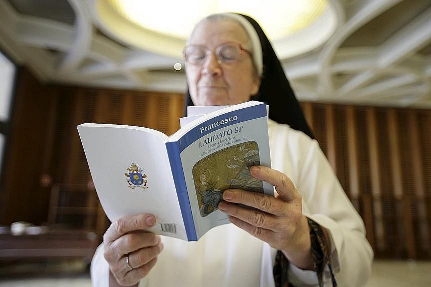 A nun reading Pope Francis' controversial encyclical in the Vatican. In the document, the pontiff says that everyone and everything is connected - to God, to creation, to fellow human beings.