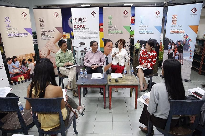 Mr Baey Yam Keng (from left), chairman of CDAC's volunteers committee, Mr Gan Kim Yong, CDAC's board chairman, and board members Low Yen Ling and Grace Fu meeting reporters after the council's 23rd AGM yesterday.