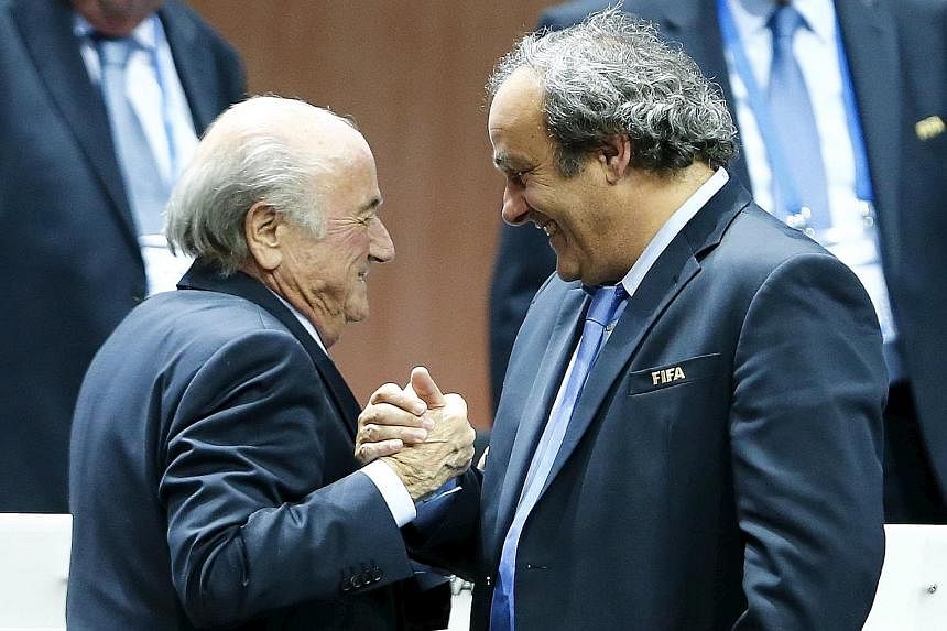 Uefa president Michel Platini (right) congratulating Fifa president Sepp Blatter after his re-election, having campaigned against him. Their feud is set to worsen.