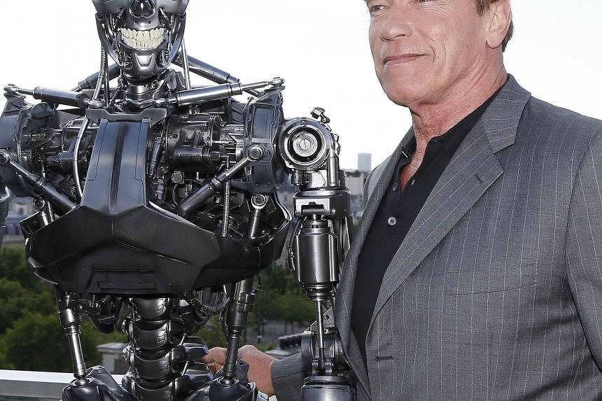 Arnold Schwarzenegger with the Terminator animatronics robot from Terminator Genisys, the latest film in the franchise.