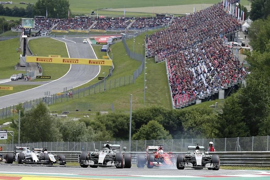 Mercedes' Nico Rosberg (front, left) leading the Austrian Grand Prix going into the second corner after overtaking pole sitter and team-mate Lewis Hamilton.