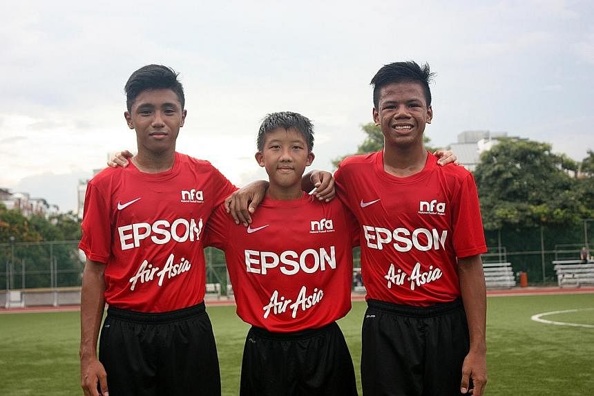 (From left) National Under-14 squad footballers Hamizan Hisham, Elijah Lim and Nur Adam Abdullah. Their stint comes under a three-year deal between the FAS and Epson, which sponsors Yamaga.