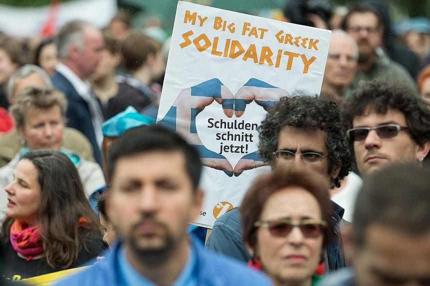 Demonstrators in Berlin voicing support for migrants during a rally held on World Refugee Day last Saturday also expressed solidarity with Greece in opposing austerity measures.