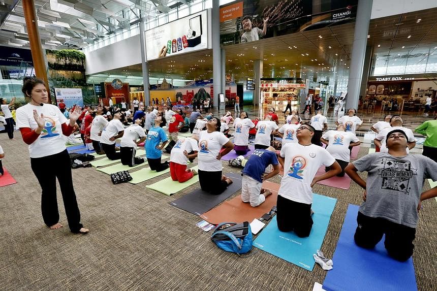 SINGAPORE: Yoga instructor Patricia Lorenz holding a session at Changi Airport yesterday. The sessions were conducted in 50 venues islandwide by yoga school Vyasa Yoga, which provided 70 teachers.