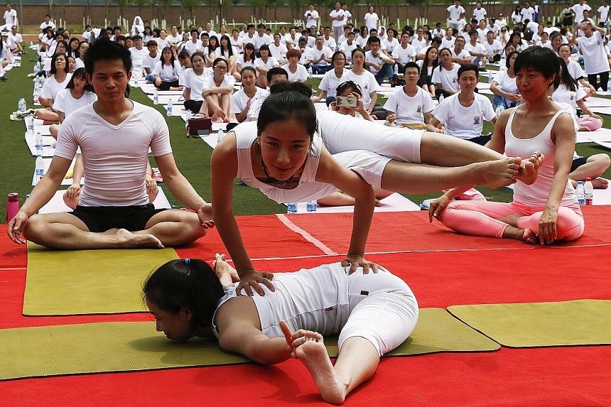BEIJING: Instructors doing poses during a session at Geely University. Mr Narendra Modi's idea for the yoga event was adopted by the UN and 177 co-sponsoring nations.
