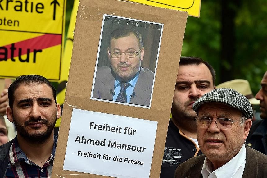 Protesters calling for the release of journalist Ahmed Mansour in Berlin's Tiergarten district, where he is being held.