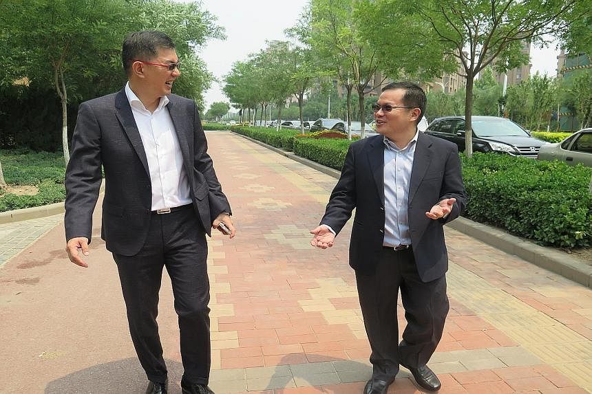 Tianjin Eco-city incoming head Liew Choon Boon (left) and outgoing chief executive Ho Tong Yen taking a stroll in the development, meant to be a model of sustainable growth for a rapidly urbanising China.