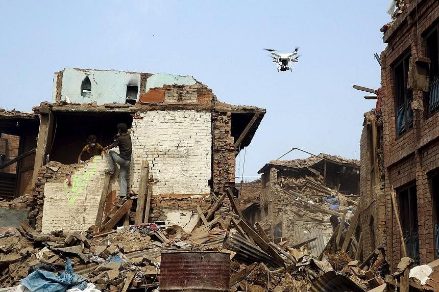 A drone flying over buildings destroyed by a 7.8-magnitude earthquake in Bhaktapur, Nepal, last month. Nepal was where an unprecedented number of drones were first used for humanitarian aid in a coordinated manner.