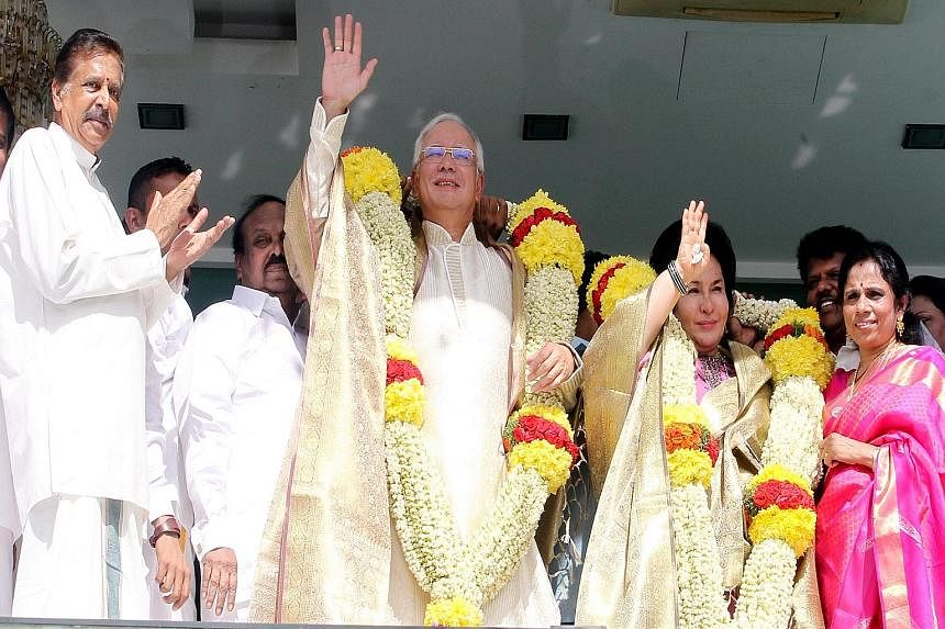 PM Najib and his wife Rosmah Mansor (with garlands) at a Thaipusam event earlier this year, along with Malaysian Indian Congress chief Palanivel Govindasamy (far left). While Mr Najib has faced increasing pressure from within his own party, Umno, he 