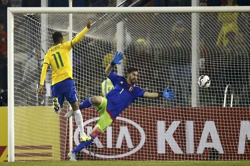Brazil's Roberto Firmino scores past Venezuela goalkeeper Alain Baroja in their 2-1 Copa America win, ensuring that the South American giants qualify for the quarter-finals as Group C winners.