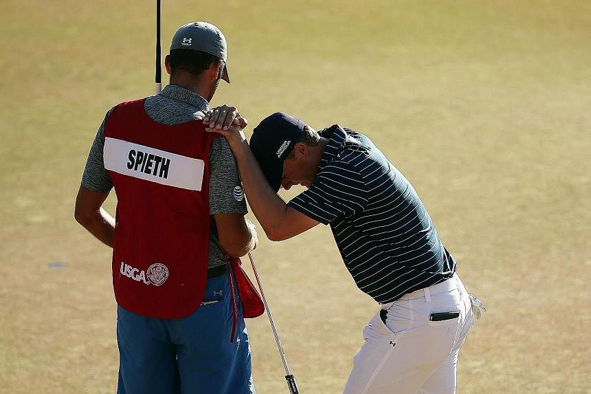 Overcome with emotion, 21-year-old Jordan Spieth leans on his caddie Michael Greller after a birdie on the 18th green during the final round of the US Open. He then had to watch as fellow American Dustin Johnson, in the last pairing, tried to hole a 
