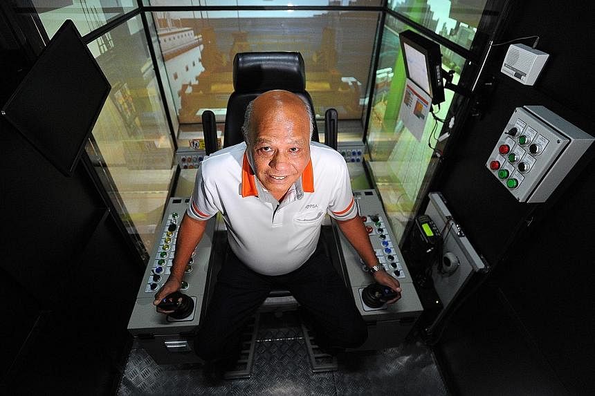 PSA Institute trainer Martin Verghese, seen here in a crane simulator, was among the first group of quay crane operators. PM Lee Hsien Loong paid tribute to workers like him yesterday.
