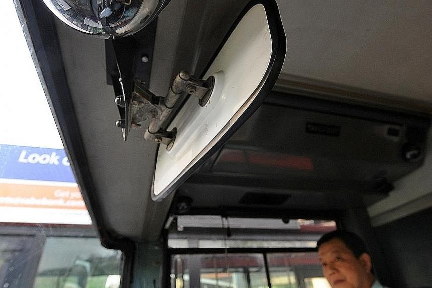 The LTA is putting up new banners like the one above to remind motorists of CCTV cameras on board buses. The cameras mounted in the front of buses (right) record instances of motorists infringing the bus-lane rule.