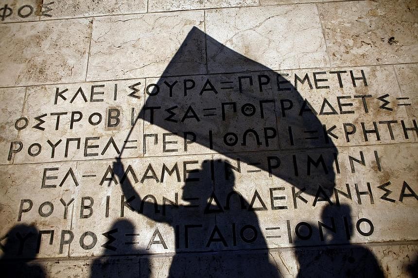 Protesters' shadows on a monument for the unknown soldier at a pro-European Union demonstration in Athens on Monday. The latest plan offered by the Greek government has been characterised as "broad and comprehensive".