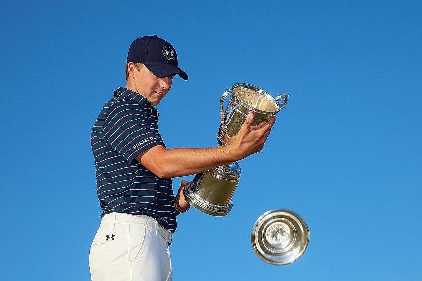 (Above) Rory McIlroy had shots to rue at the US Open and his 66 on the final day could not make up for his slow start. (Left) Jordan Spieth can afford a smile as the top of the US Open trophy falls off since he has won two Majors at just age 21.